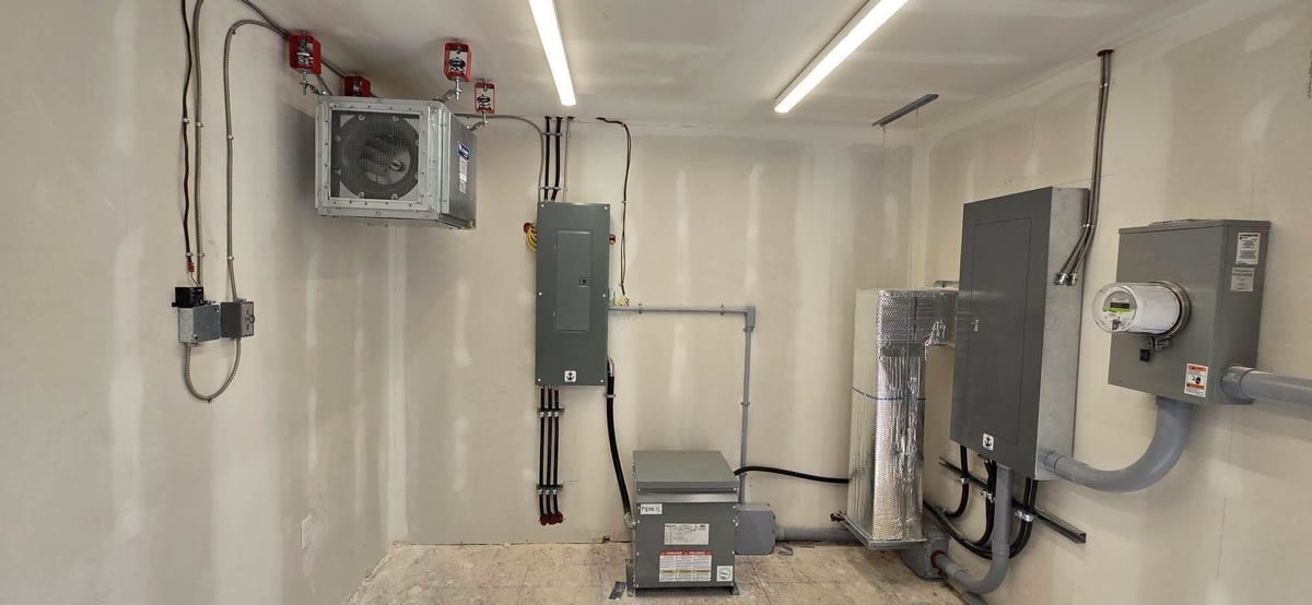 A mechanical room with service equipment, disconnects and conduit runs.