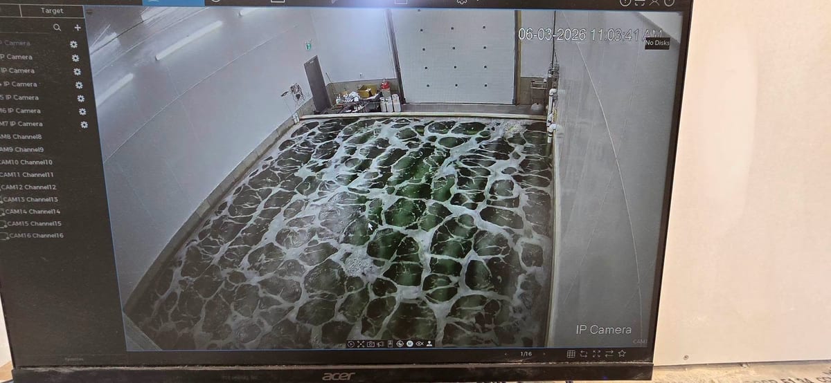A camera view of a facility interior displayed on a wall-mounted monitor.